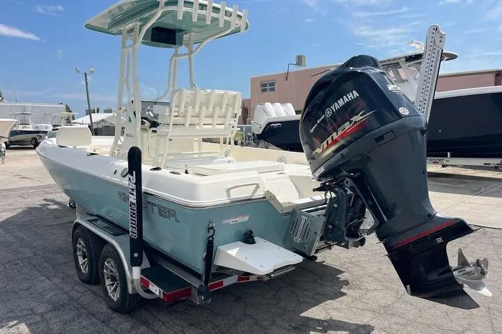 Slide: The Image of 2021 Skeeter SX2250 boat with Yamaha outboard motor on a trailer, parked outdoors. - 1