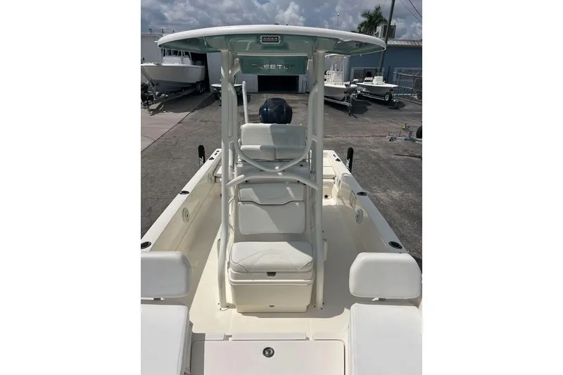Slide: The Image of 2021 Skeeter SX2250 boat with center console and seating, docked outdoors. - 10