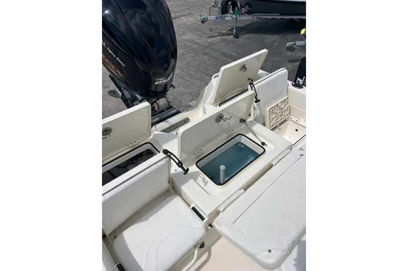 Slide: The Image of 2021 Skeeter SX2250 boat interior with open storage compartments and Yamaha outboard motor. - 13