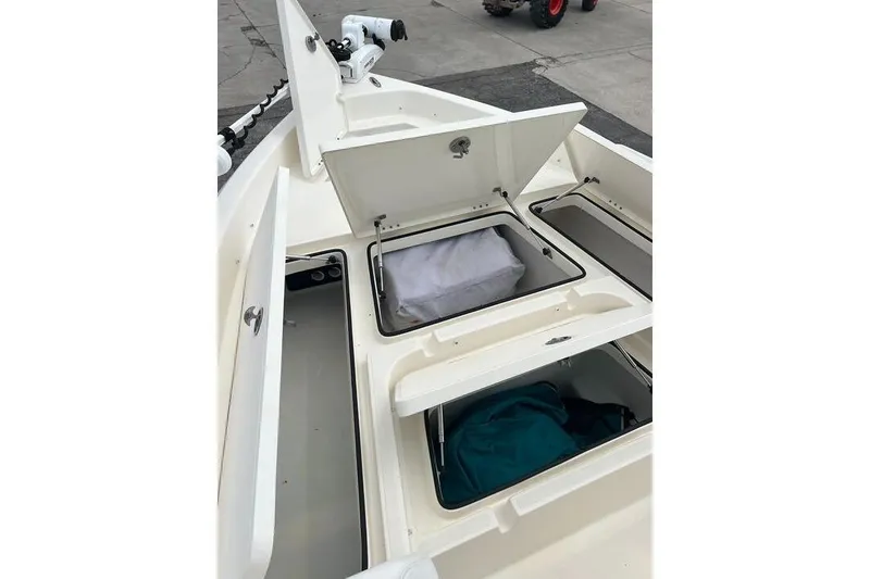 Slide: The Image of 2021 Skeeter SX2250 boat storage compartments open, showcasing interior space and organization. - 19