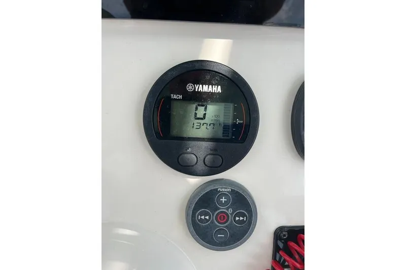 Slide: The Image of Yamaha tachometer and Fusion audio control on 2021 Skeeter SX2250 boat dashboard. - 21