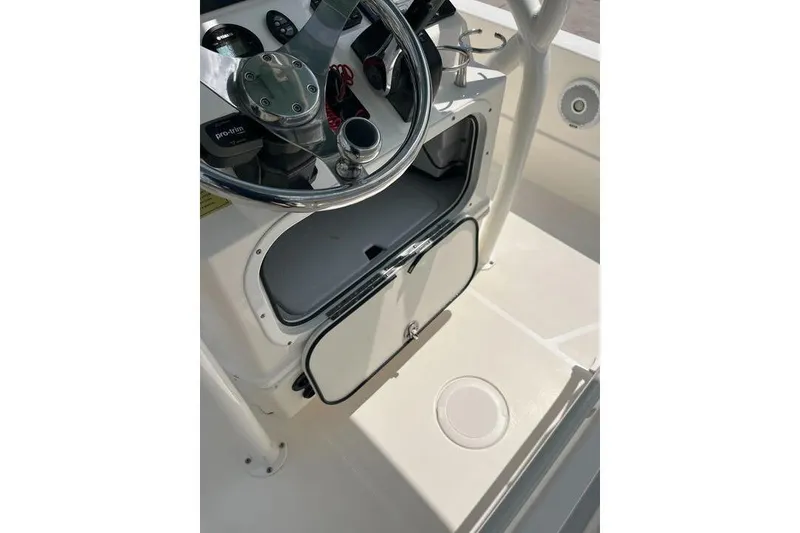 Slide: The Image of 2021 Skeeter SX2250 boat console with steering wheel and storage compartment. - 22