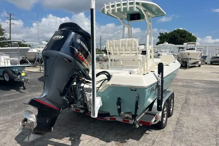 Slide: The Image of 2021 Skeeter SX2250 boat with Yamaha outboard motor, parked on a trailer under a blue sky. - 3
