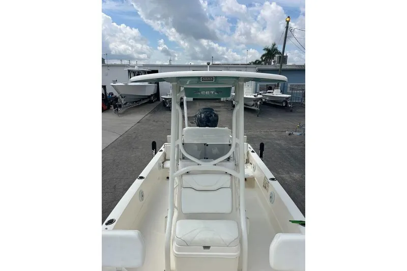 Slide: The Image of 2021 Skeeter SX2250 boat with T-top, parked outdoors under cloudy sky. - 4