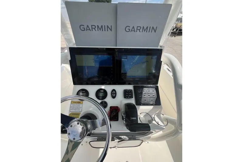 Slide: The Image of 2021 Skeeter SX2250 boat console with dual Garmin displays and navigation controls. - 5