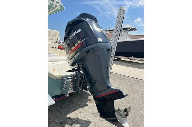 Slide: The Image of 2021 Skeeter SX2250 boat with Yamaha outboard motor, parked outdoors. - 6