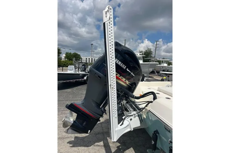 Slide: The Image of 2021 Skeeter SX2250 boat with Yamaha outboard motor, parked outdoors under cloudy sky. - 8