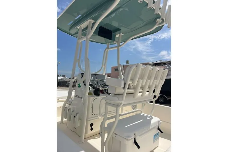 Slide: The Image of 2021 Skeeter SX2250 boat interior with T-top and seating under clear blue sky. - 9