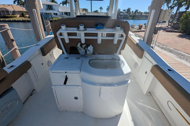 Slide: The Image of 2021 Sea Hunt Gamefish 30 boat interior with forward seating and fishing rod holders. - 11