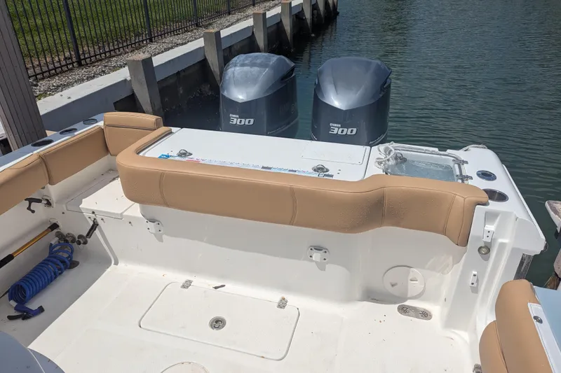 Slide: The Image of 2021 Sea Hunt Gamefish 30 boat with twin Yamaha 300 engines, docked by the water. - 12