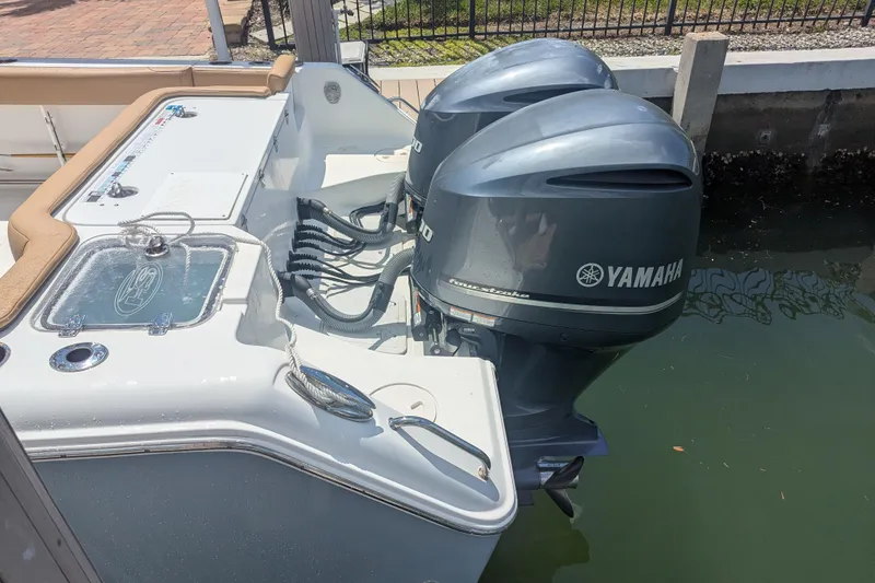 Slide: The Image of 2021 Sea Hunt Gamefish 30 with twin Yamaha outboard motors docked by water. - 13