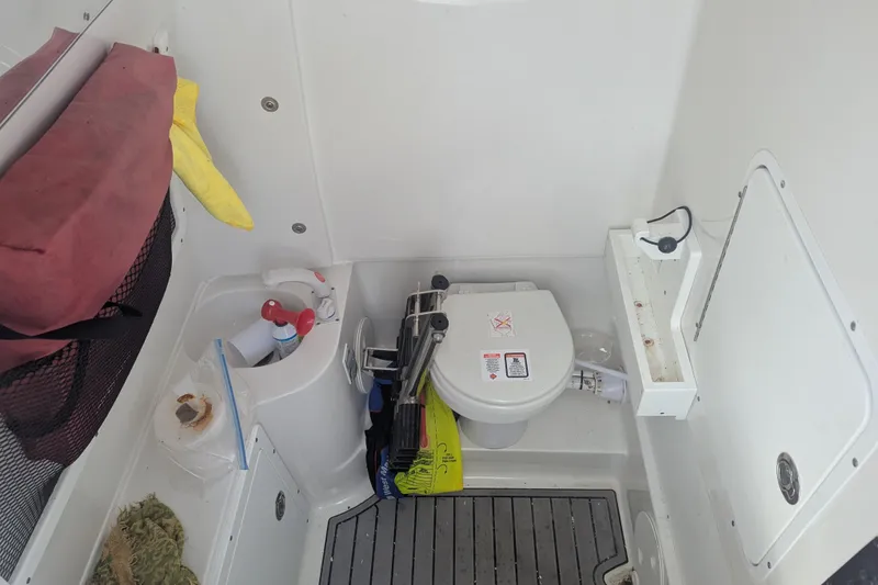 Slide: The Image of 2021 Sea Hunt Gamefish 30 boat interior with toilet and storage area. - 14