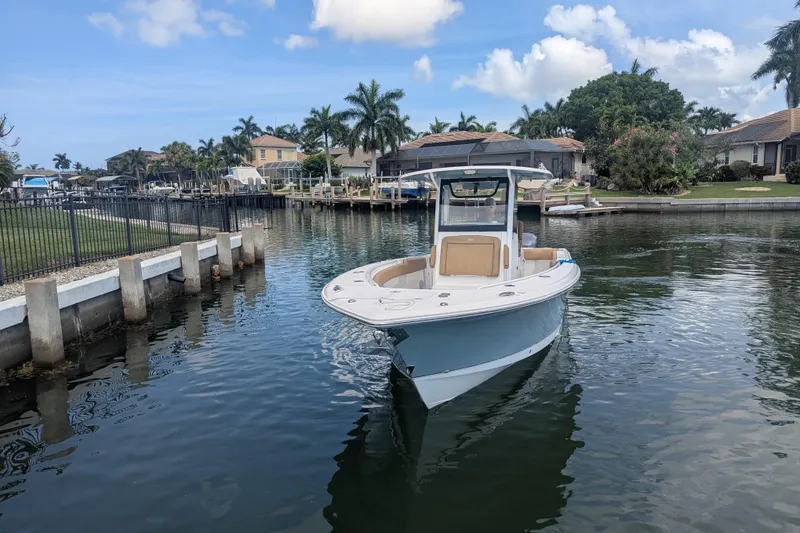 Slide: The Image of 2021 Sea Hunt Gamefish 30 boat docked in a scenic residential canal. - 5