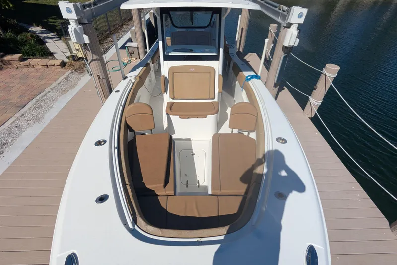 Slide: The Image of 2021 Sea Hunt Gamefish 30 boat with forward seating, docked by the water. - 8