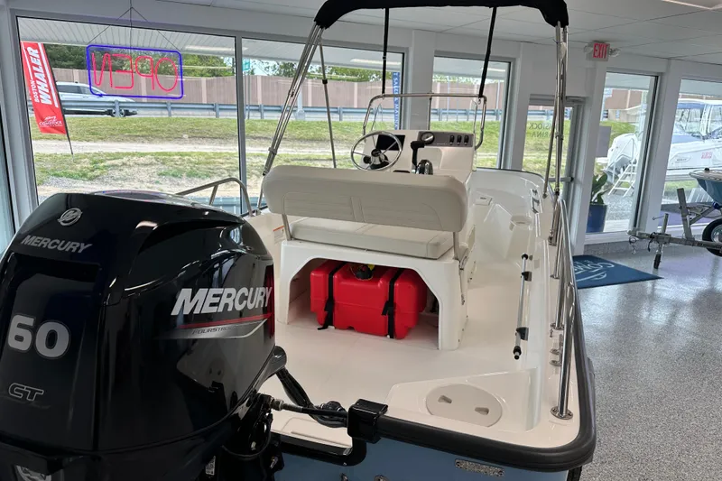 Slide: The Image of 2026 Boston Whaler 150 Montauk boat with Mercury 60 engine in showroom. - 20