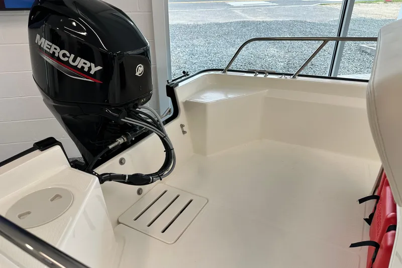 Slide: The Image of 2026 Boston Whaler 150 Montauk boat interior with Mercury outboard motor. - 21