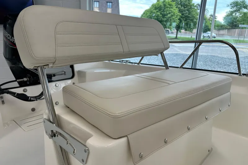 Slide: The Image of 2026 Boston Whaler 150 Montauk boat seat, featuring white cushioned upholstery and sleek design. - 23