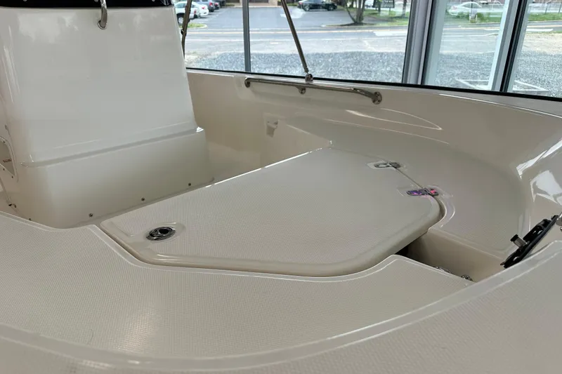 Slide: The Image of 2026 Boston Whaler 150 Montauk interior, showcasing sleek design and spacious seating area. - 26