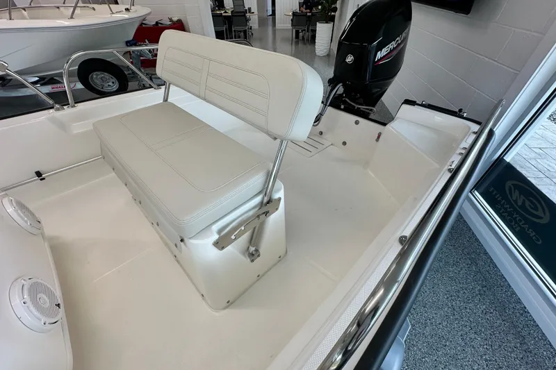 Slide: The Image of 2026 Boston Whaler 150 Montauk boat interior with seating and Mercury engine. - 27