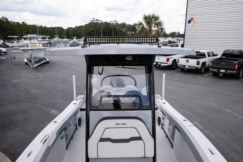 Slide: The Image of 2026 Sea Pro 245FLXR Sandbar boat at marina, surrounded by trucks and trailers. - 18