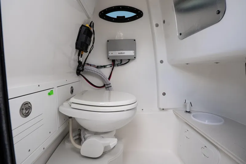Slide: The Image of Interior of 2026 Sea Pro 245FLXR Sandbar boat bathroom with toilet and sink. - 20