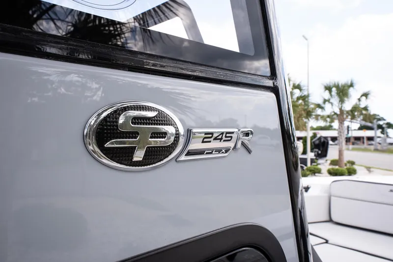 Slide: The Image of 2026 Sea Pro 245FLXR Sandbar boat emblem with palm trees in the background. - 21
