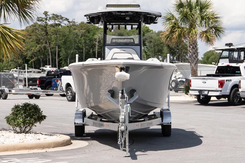 Slide: The Image of 2026 Sea Pro 245FLXR Sandbar boat on trailer, parked outdoors near palm trees. - 3