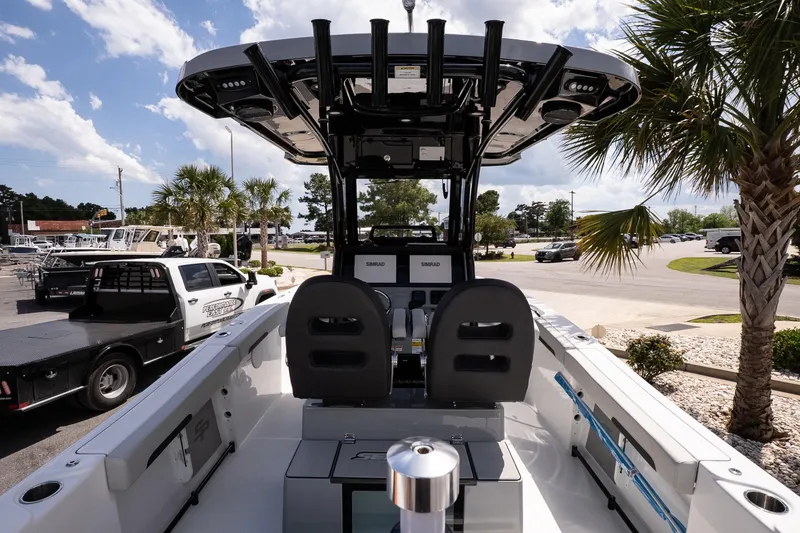 Slide: The Image of 2026 Sea Pro 245FLXR Sandbar boat interior with palm trees and parked vehicles. - 6