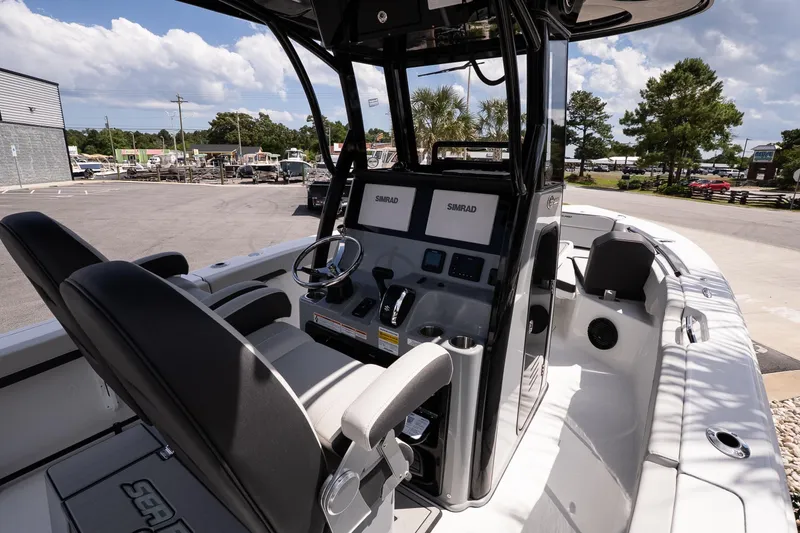 Slide: The Image of 2026 Sea Pro 245FLXR Sandbar boat interior with modern controls and seating. - 9
