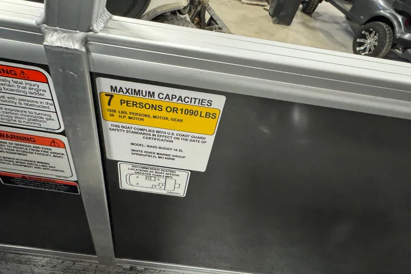 Slide: The Image of 2026 Sun Tracker Bass Buggy 16 XL Select capacity label, 7 persons or 1090 lbs limit. - 11