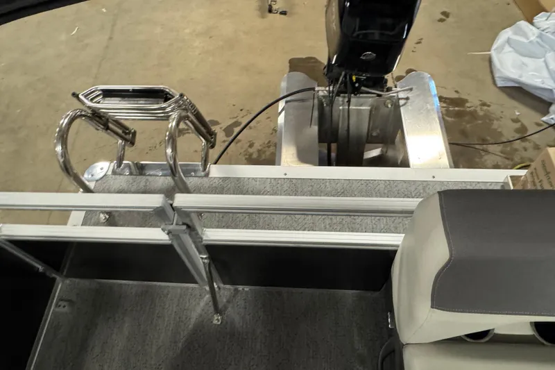 Slide: The Image of 2026 Sun Tracker Bass Buggy 16 XL Select pontoon boat interior with motor and seating. - 12