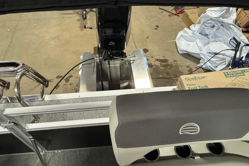 Slide: The Image of 2026 Sun Tracker Bass Buggy 16 XL Select pontoon boat interior with motor and fuel tank. - 13