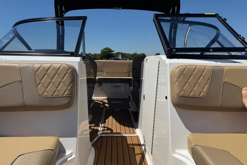 Slide: The Image of 2024 Bayliner VR6 Bowrider OB interior with tan upholstery and open windshield. - 10