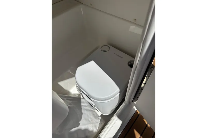 Slide: The Image of 2024 Bayliner VR6 Bowrider OB boat toilet compartment with compact design. - 11
