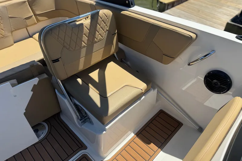 Slide: The Image of 2024 Bayliner VR6 Bowrider OB interior with tan seating and wood-style flooring. - 14