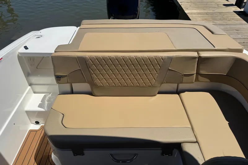 Slide: The Image of 2024 Bayliner VR6 Bowrider OB with tan cushioned seating and elegant diamond stitching. - 16