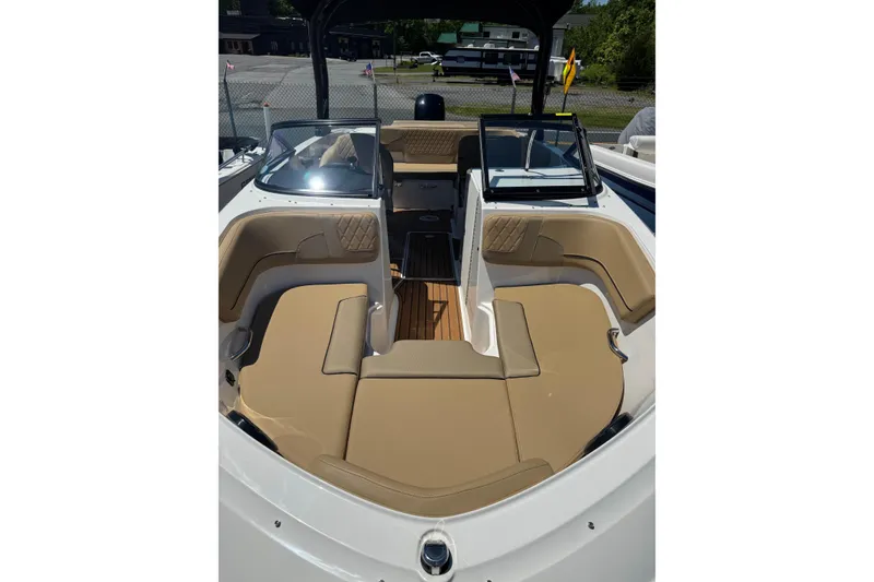 Slide: The Image of 2024 Bayliner VR6 Bowrider OB interior with tan seating and open bow design. - 17