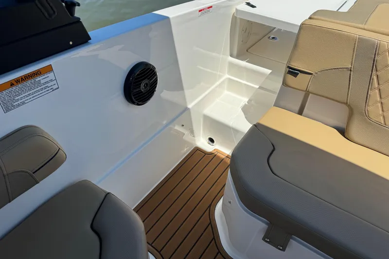 Slide: The Image of 2024 Bayliner VR6 Bowrider OB interior with tan seating and marine speaker. - 18