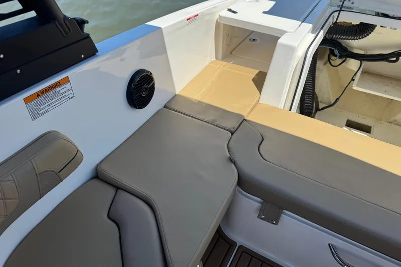 Slide: The Image of 2024 Bayliner VR6 Bowrider OB interior with cushioned seating and speaker detail. - 19