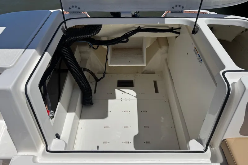 Slide: The Image of 2024 Bayliner VR6 Bowrider OB engine compartment, open and empty, showcasing interior space. - 21