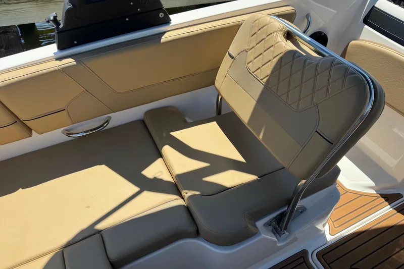 Slide: The Image of 2024 Bayliner VR6 Bowrider OB interior with tan seating and stainless steel accents. - 23