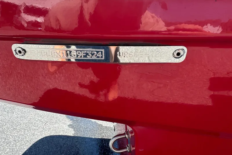 Slide: The Image of 2024 Bayliner VR6 Bowrider OB, red exterior, close-up of identification plate. - 24
