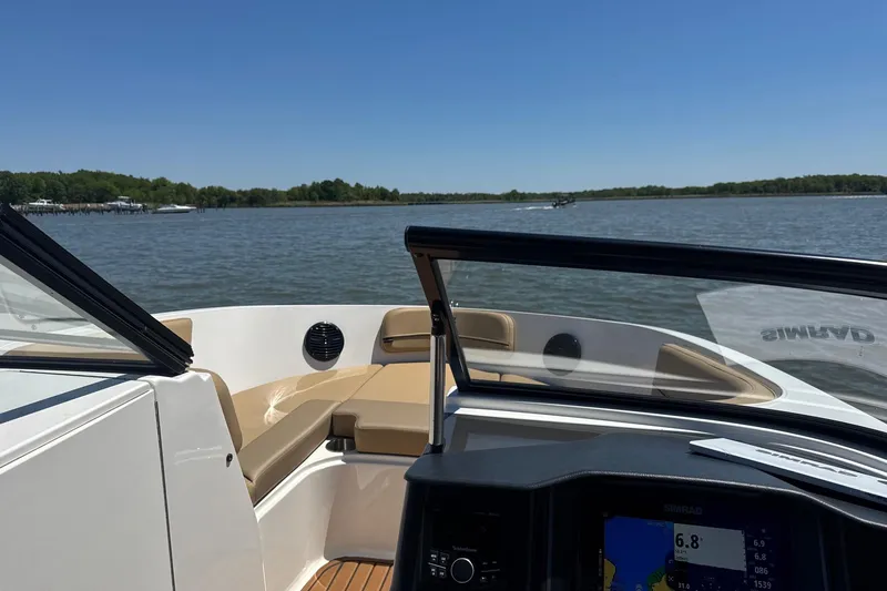 Slide: The Image of 2024 Bayliner VR6 Bowrider OB cruising on a serene lake under clear skies. - 9