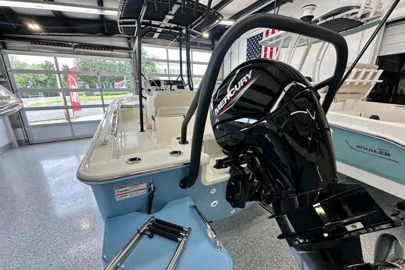 Slide: The Image of 2026 Boston Whaler 190 Montauk boat with Mercury engine in showroom. - 19