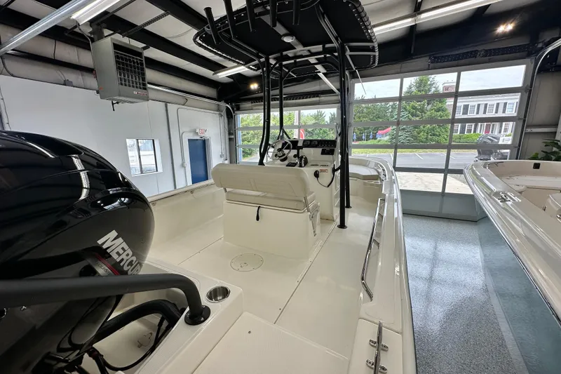 Slide: The Image of 2026 Boston Whaler 190 Montauk boat in showroom, featuring Mercury engine and modern design. - 20