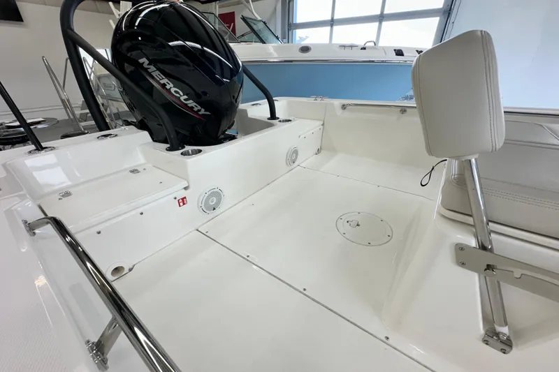 Slide: The Image of 2026 Boston Whaler 190 Montauk boat interior with Mercury engine, showcasing sleek design and seating. - 21