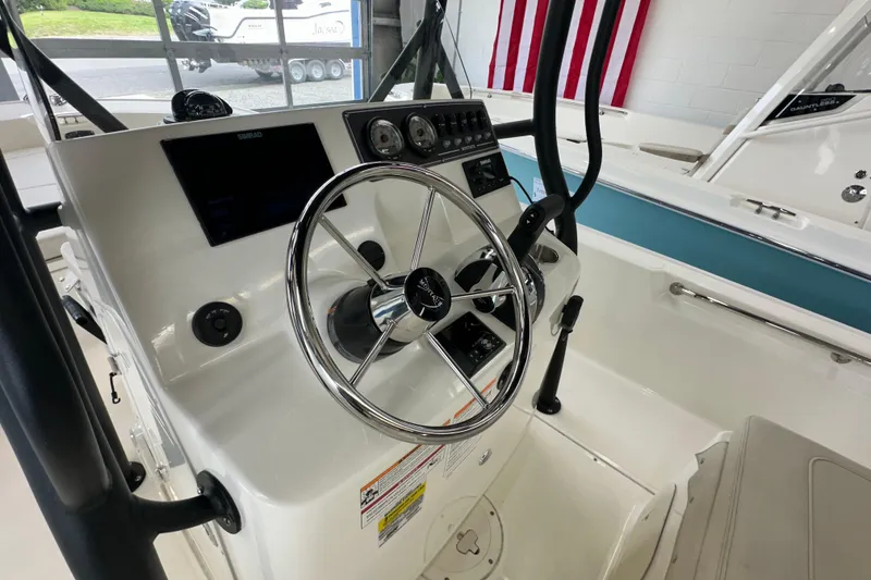 Slide: The Image of 2026 Boston Whaler 190 Montauk boat console with steering wheel and navigation controls. - 27