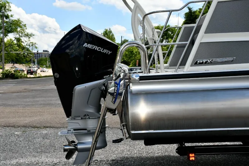 Slide: The Image of 2024 Premier 250 RL PTX pontoon boat with Mercury outboard motor, parked outdoors. - 7