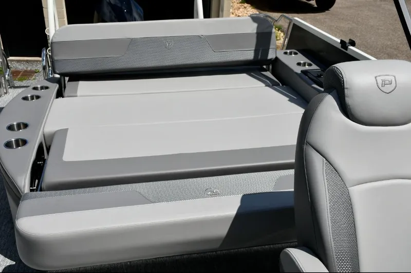 Slide: The Image of 2024 Premier 250 RL PTX boat interior with luxurious gray seating and cup holders. - 8
