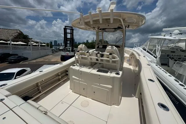 The Image of 2017 Grady-White Canyon 306 boat with spacious deck and dual console, docked under cloudy skies. - 1